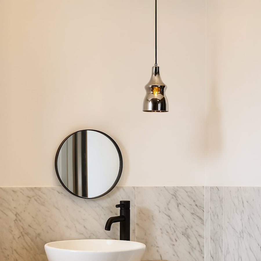 Modern pendant light styled in a warm lifestyle setting showcasing its glossy chrome curved body and elegant hanging design beautifully.