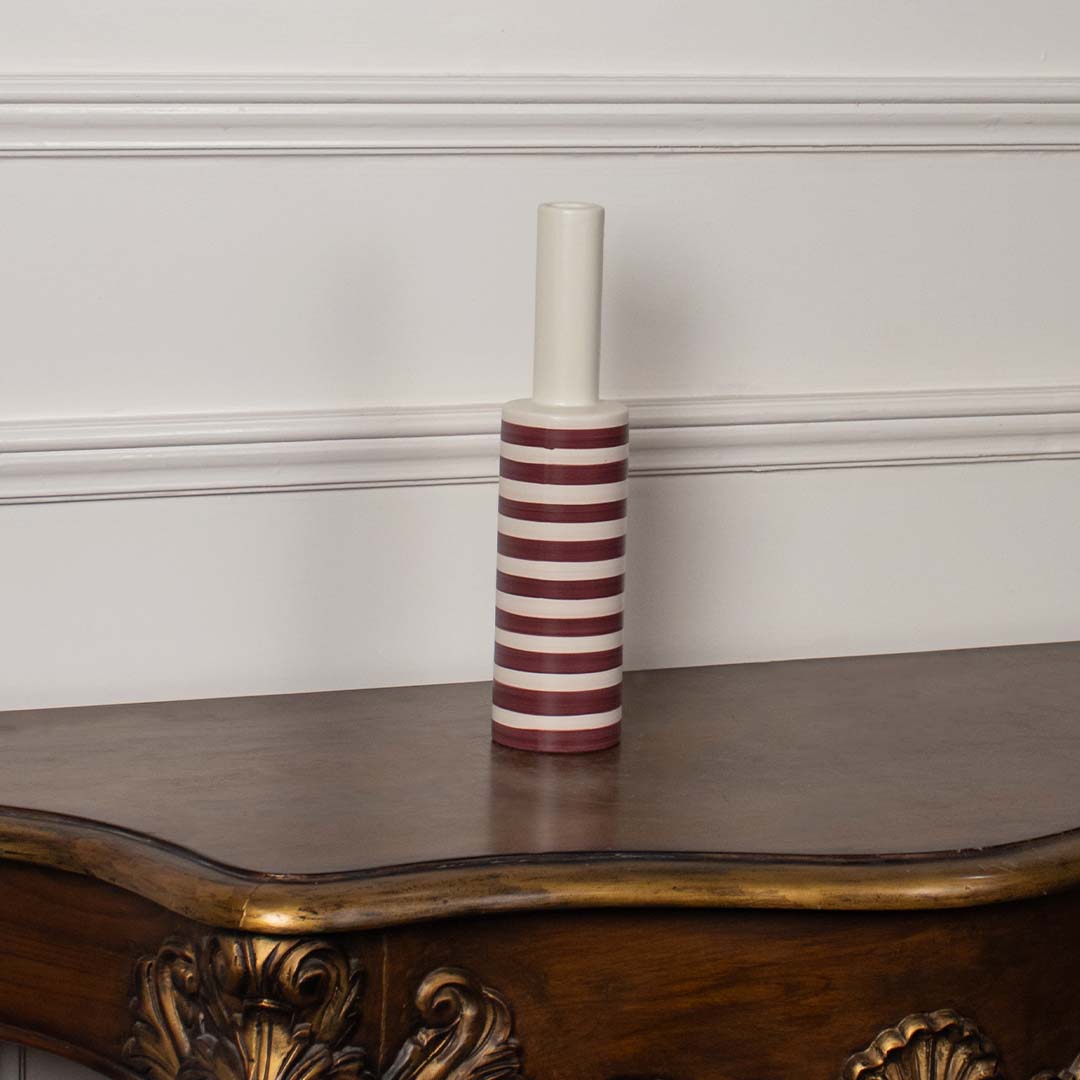 A modern striped vase presented against a plain white background focusing on its slim cylindrical form and bold horizontal stripes for a clean visual.