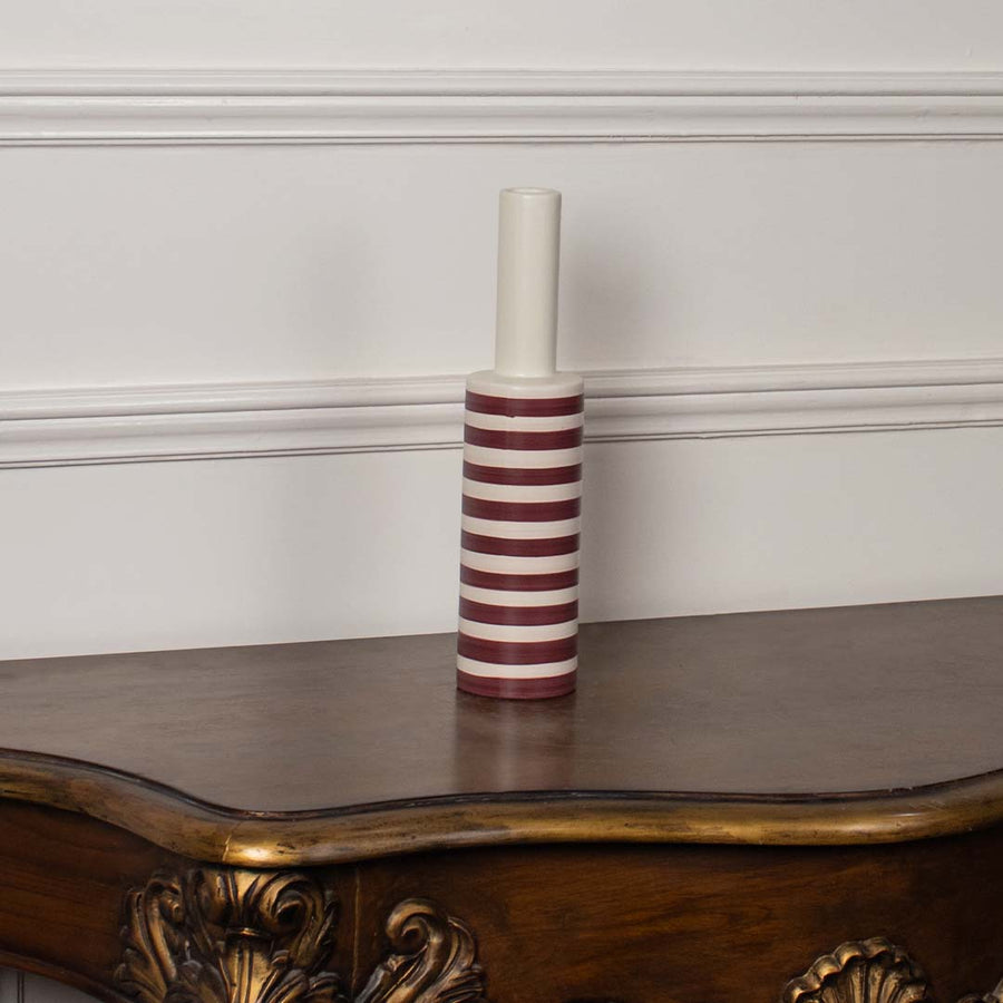 A modern striped vase presented against a plain white background focusing on its slim cylindrical form and bold horizontal stripes for a clean visual.