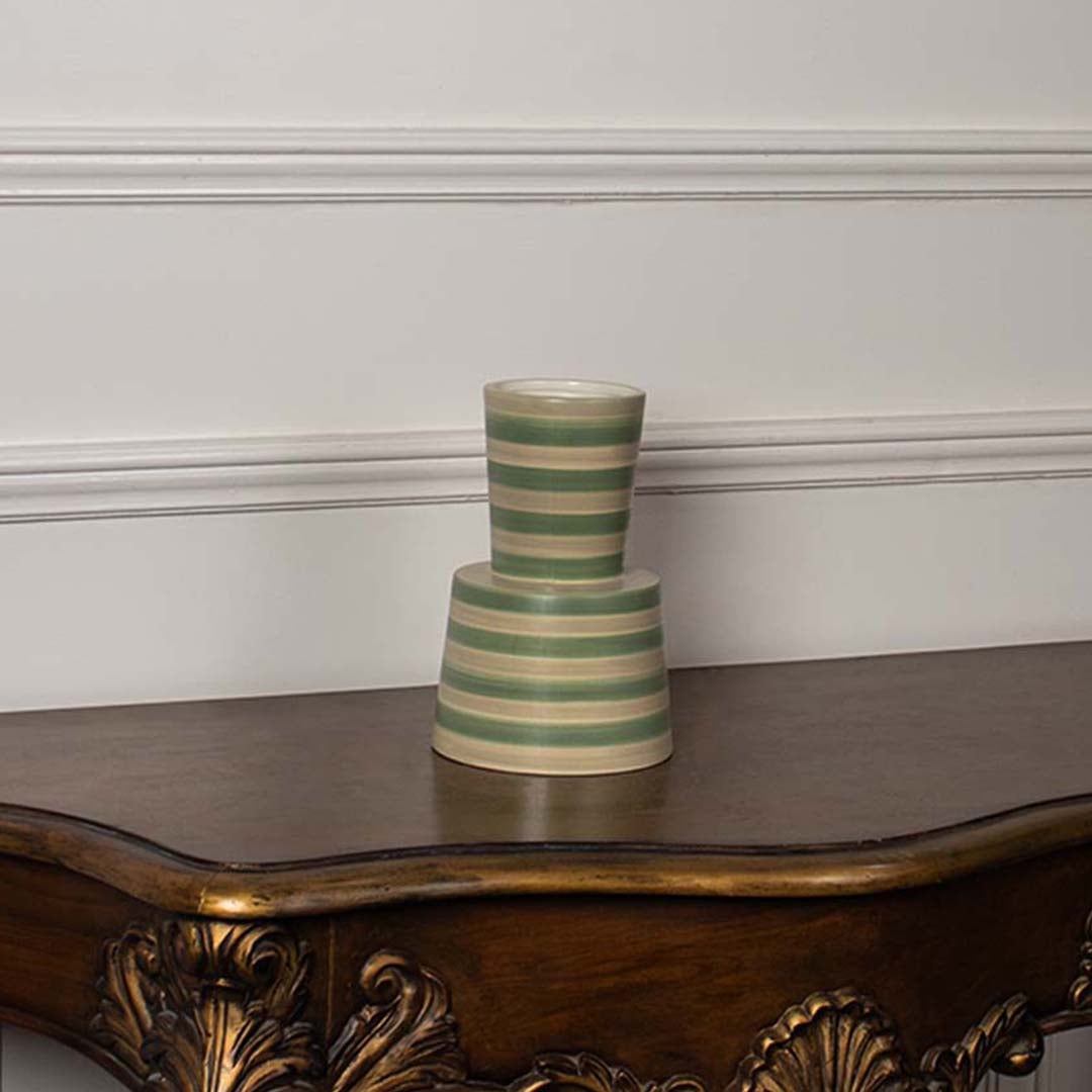 A green and beige striped ceramic vase photographed on a clean white background  showcasing its tapered design and modern handcrafted style.