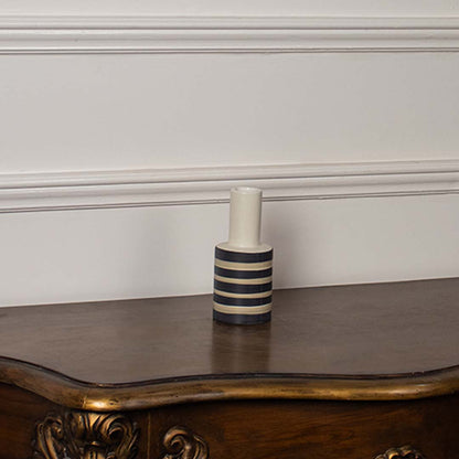 Black and beige striped ceramic vase on white background highlighting its minimalistic design ideal for modern interiors.