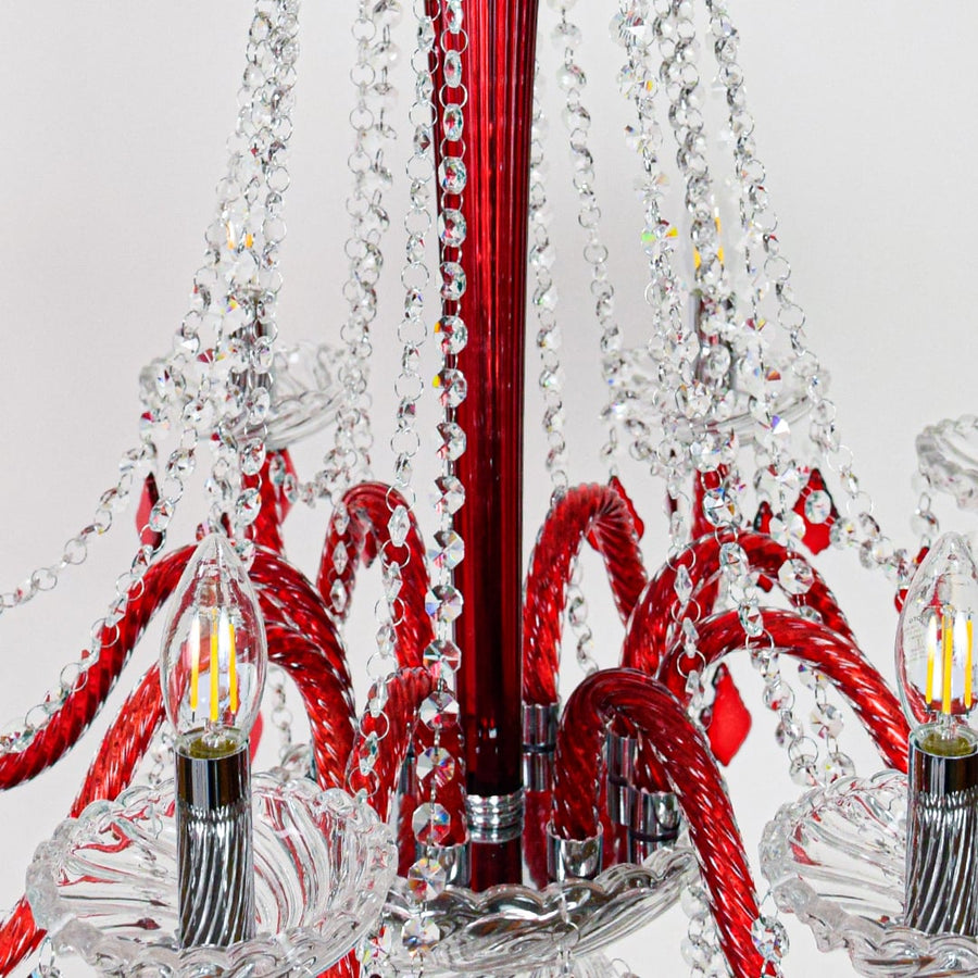 Closeup of red and clear crystal chandelier with detailed crystal strands perfect for luxury interior ceiling lighting.