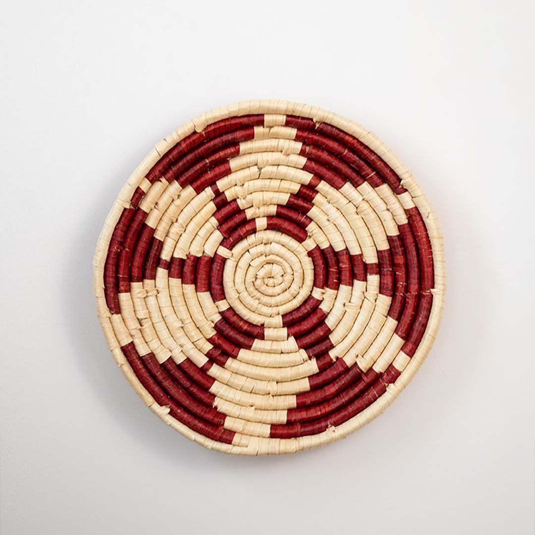 Red and natural woven decorative wall basket with floral pattern for elegant wall styling and contemporary home decor.