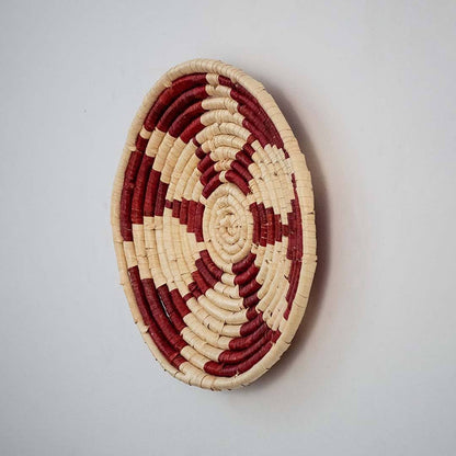 Handwoven woven wall basket decor in natural beige and burgundy with raised woven profile shown on white background.