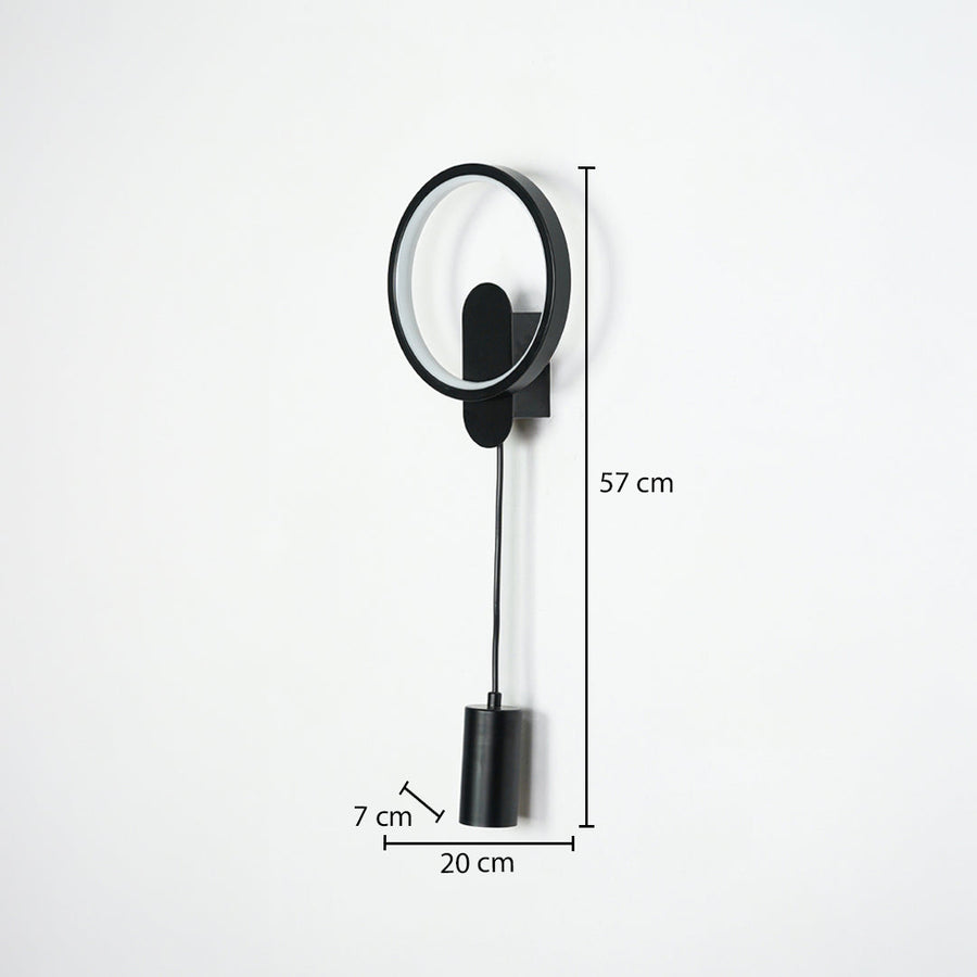 Black wall light with circular frame and hanging cylindrical pendant on neutral wall background 57 cm height 20 cm width 7 cm depth perfect for contemporary interior lighting.