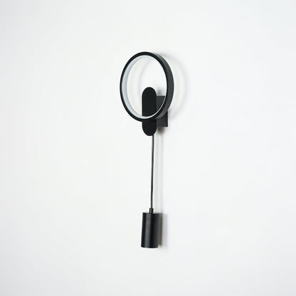 Black wall light with circular LED ring and cylindrical spotlight mounted on neutral wall background ideal for modern bedroom or hallway lighting.