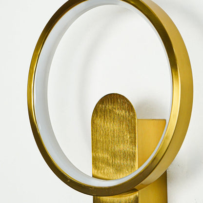 Close view of gold wall light with round frame and textured metal spotlight shade highlighting premium modern decorative lighting design.

