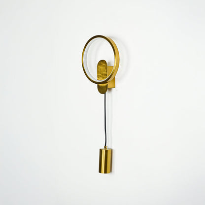 Modern gold wall light with circular frame and downward spotlight mounted on white wall background ideal for stylish bedroom or hallway lighting.