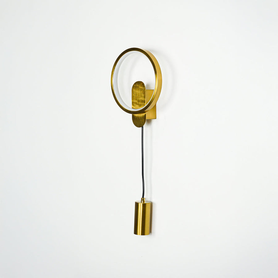 Modern gold wall light with circular frame and downward spotlight mounted on white wall background ideal for stylish bedroom or hallway lighting.