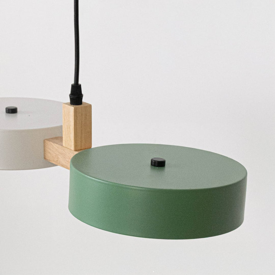 Closeup of green metal ceiling canopy and wood accents highlighting refined modern craftsmanship.