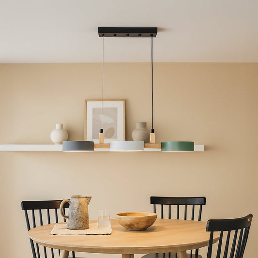Modern wood and metal triple pendant light in grey white and green shades adding stylish ambient lighting to a contemporary room.