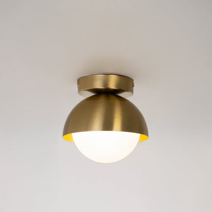Modern gold metal ceiling light with white glass globe for luxury bedroom and premium interior decor spaces.