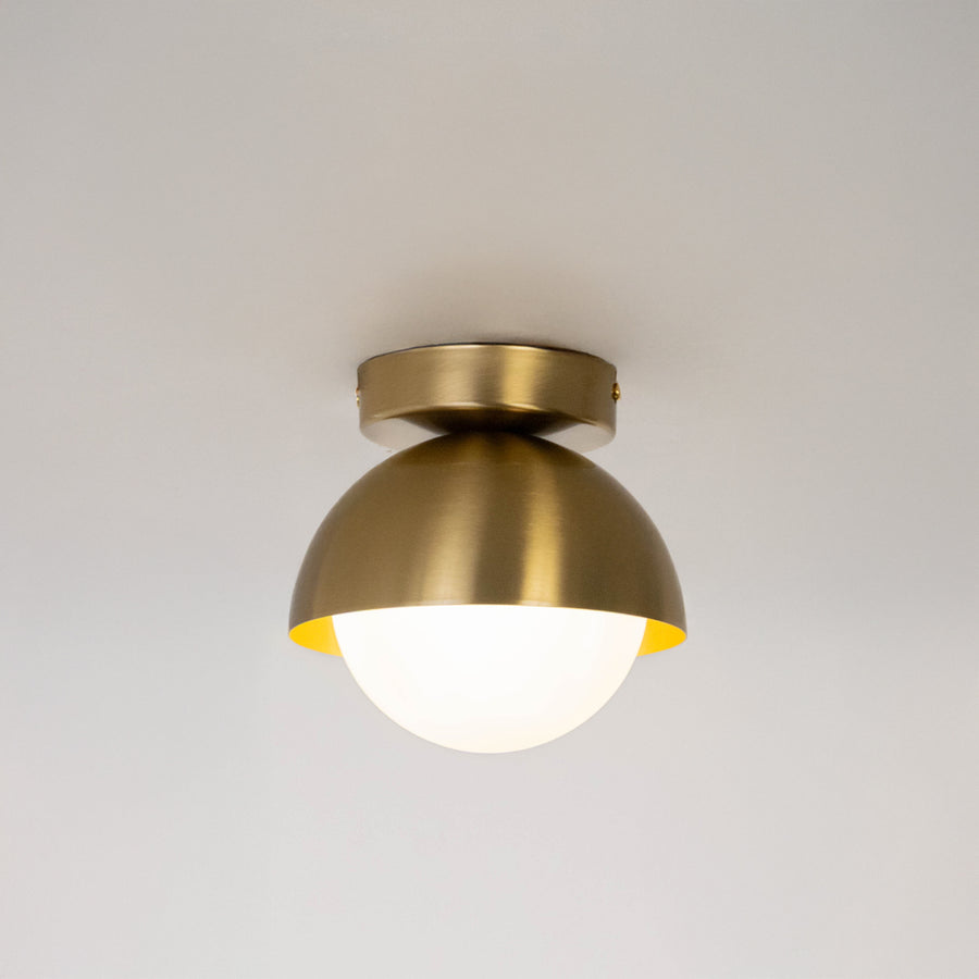 Modern gold metal ceiling light with white glass globe for luxury bedroom and premium interior decor spaces.