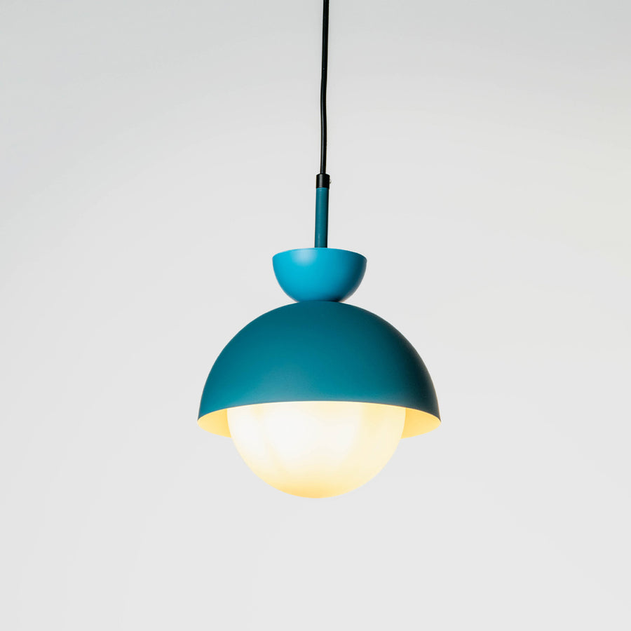 Blue metal pendant light with yellow diffuser crafted for stylish contemporary living spaces.