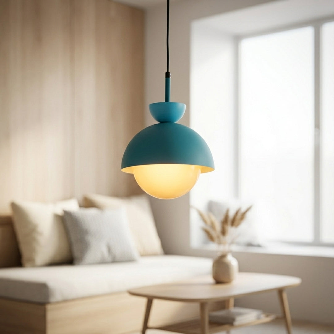 Blue metal pendant light with yellow accents above coffee table adding playful modern elegance indoors.