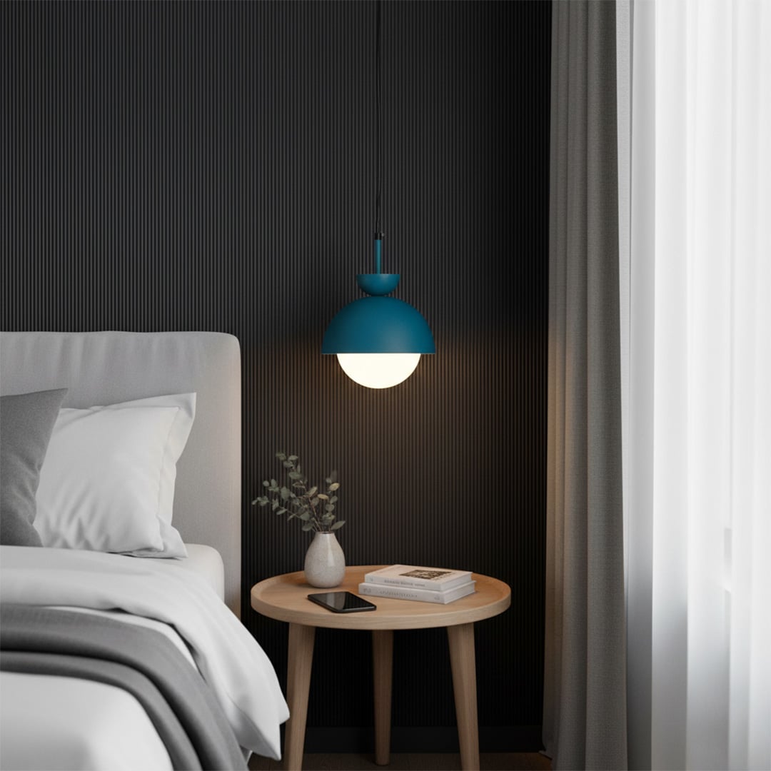 Blue pendant light above bedside table bringing soft illumination and contemporary sophistication.