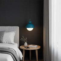 Blue pendant light above bedside table bringing soft illumination and contemporary sophistication.