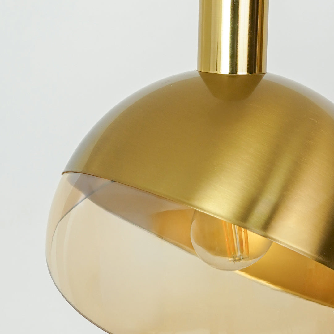 Closeup of brushed gold metal pendant light highlighting smooth finish and refined details.