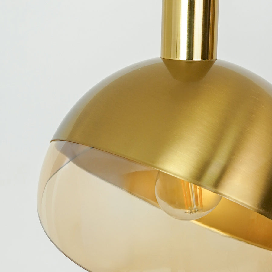 Closeup of brushed gold metal pendant light highlighting smooth finish and refined details.