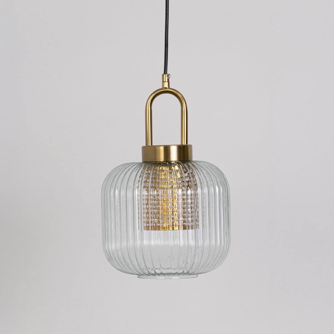 Clear ribbed glass and gold metal pendant light designed for stylish kitchen and dining room decor.