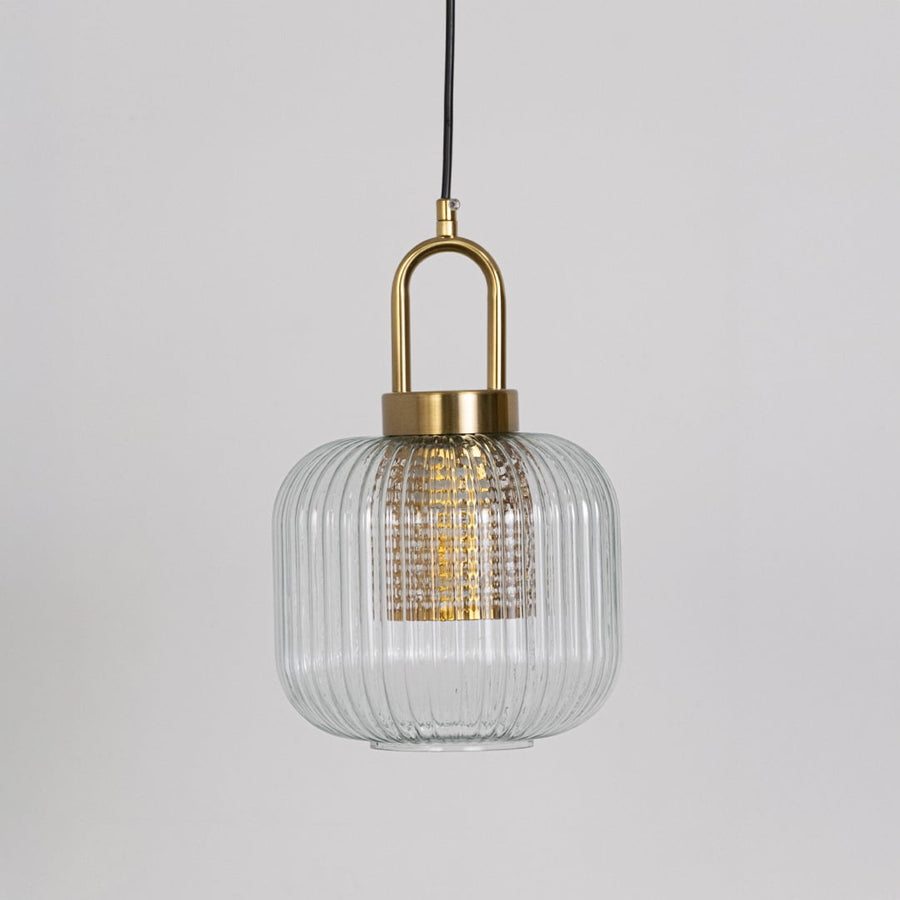 Clear ribbed glass and gold metal pendant light designed for stylish kitchen and dining room decor.