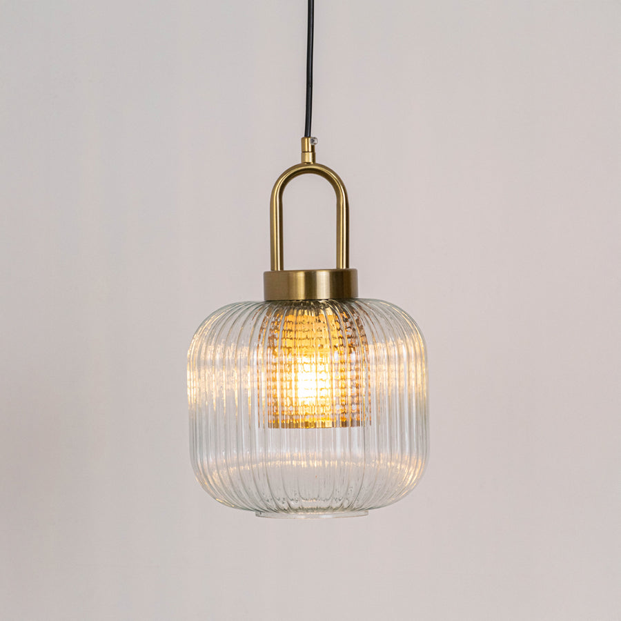 Modern pendant light in gold metal finish with ribbed glass shade for kitchen or dining decor lighting white background.