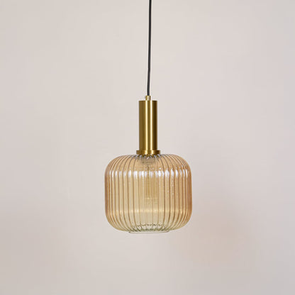 Modern gold metal and ribbed glass pendant light switched off on white background designed for ceiling mounted decor.