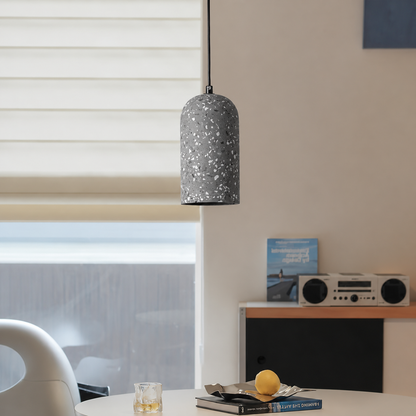 Lifestyle image of nordic terrazzo cement pendant light in dark grey for elegant dining room decor styling and lighting.