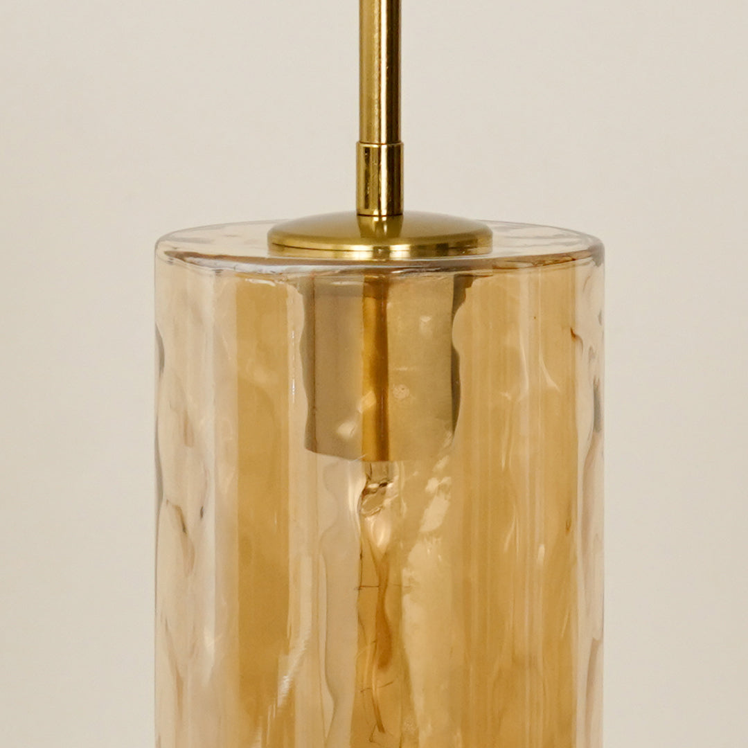 Amber textured glass pendant light with gold fittings adding elegant charm to modern ceiling decor.
