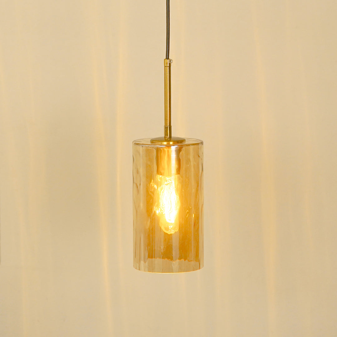 Amber ribbed glass pendant light illuminated warmly for stylish ceiling lighting.