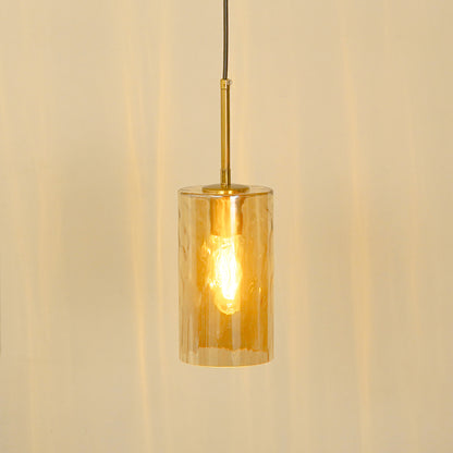 Amber ribbed glass pendant light illuminated warmly for stylish ceiling lighting.