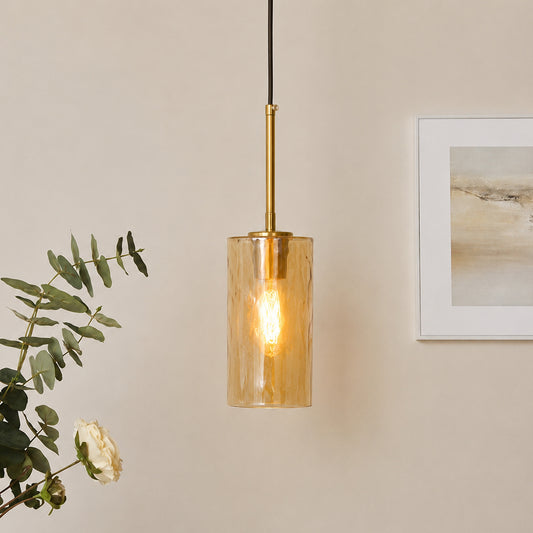 Amber ribbed glass pendant light with gold finish enhancing sophisticated home interiors.