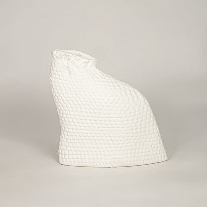 White ceramic decorative vase with textured organic silhouette for minimalist tabletop styling and home decor displays.