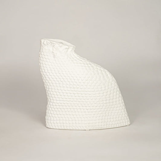 White ceramic decorative vase with textured organic silhouette for minimalist tabletop styling and home decor displays.