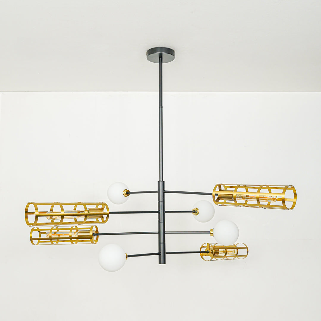 Modern chandelier with black metal arms and gold cage shades mounted on ceiling in neutral background ideal for contemporary interior lighting.