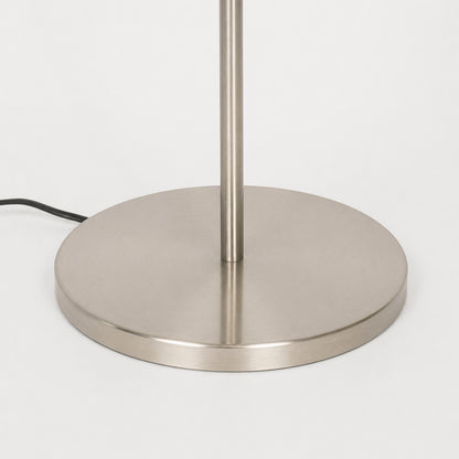 Closeup image of linear silver metal floor lamp base for elegant living room decor styling and modern home lighting setup.