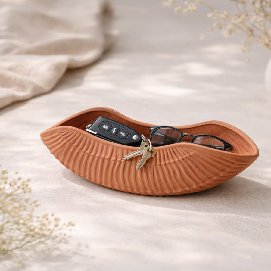 Terracotta ceramic decorative shell bowl with textured design perfect for fruit display on dining table centerpiece and modern home decor.