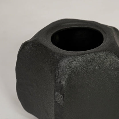 Closeup of black ceramic planter with sculpted matte texture for elegant tabletop and shelf decor styling ideas.
