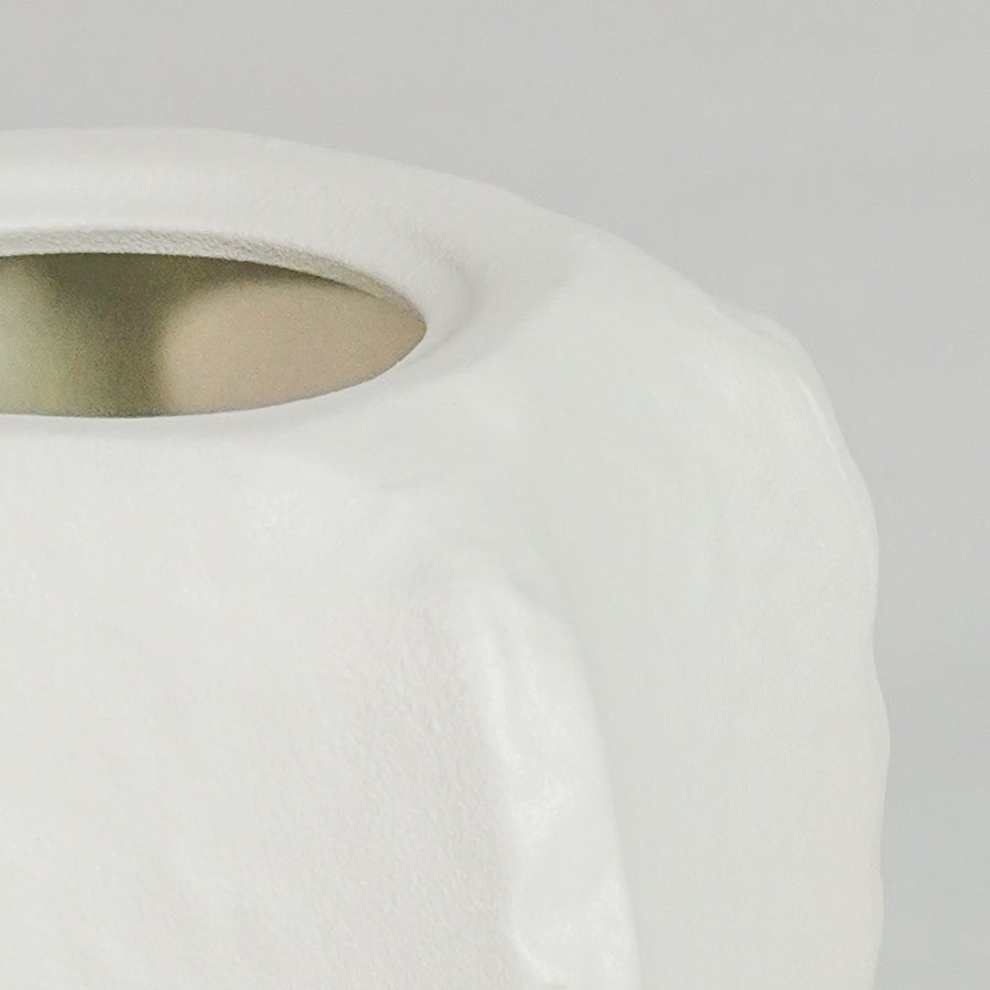 Closeup image of small white ceramic vase with lid for elegant tabletop decor styling highlighting smooth modern finish.