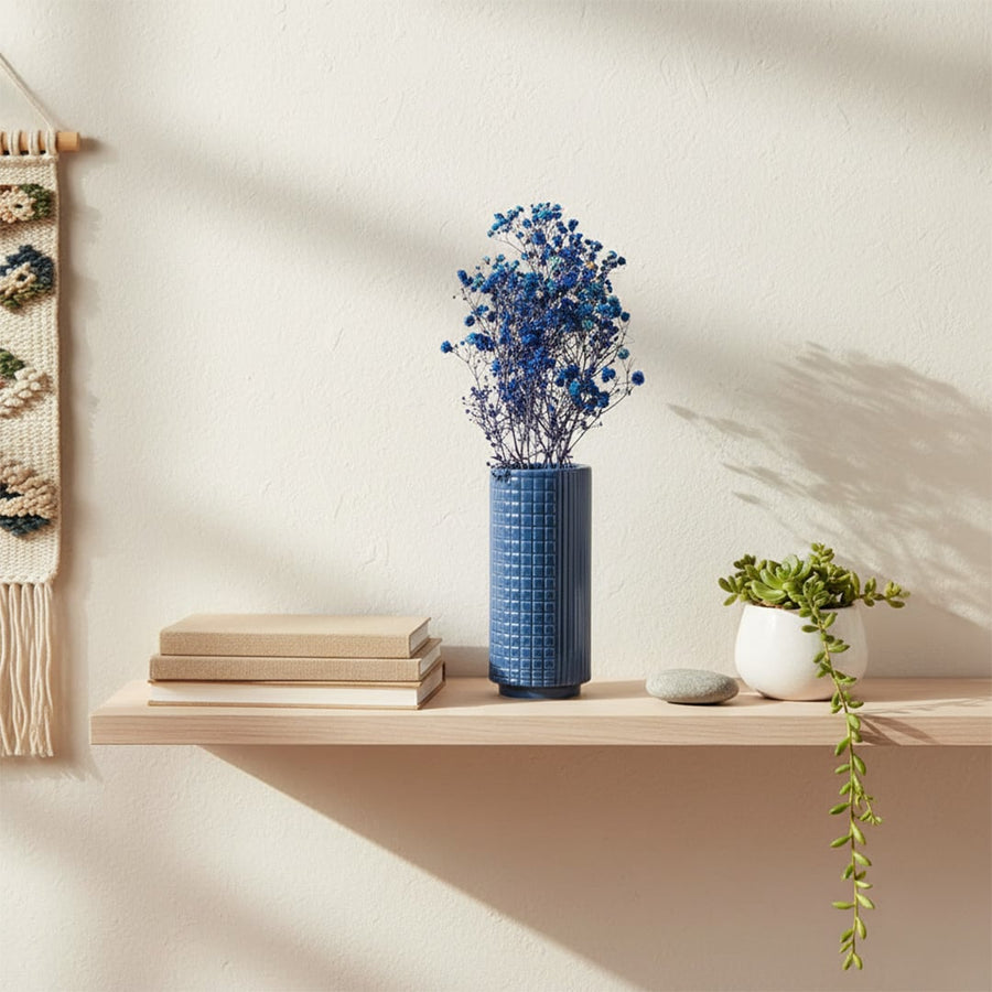 Blue ceramic textured vase styled for modern home decor ideal for placing on shelves tables and living spaces to enhance interiors.