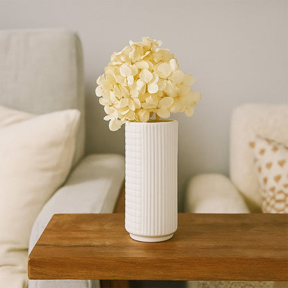 White ceramic textured vase styled for modern home decor ideal for shelves tables and minimal living spaces.