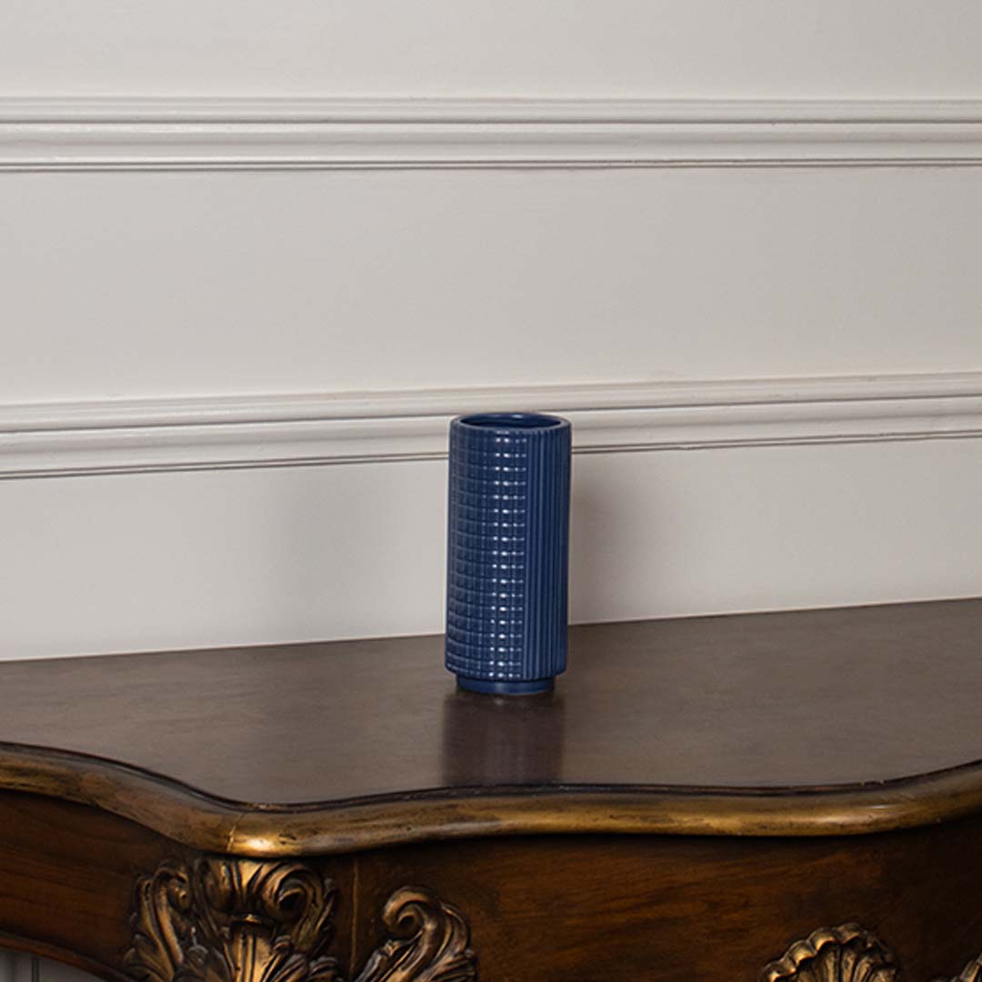 Blue textured ceramic vase displayed on a clean white background ideal for sleek home decor and elegant tabletop styling.