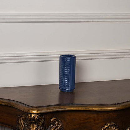 Blue textured ceramic vase displayed on a clean white background ideal for sleek home decor and elegant tabletop styling.