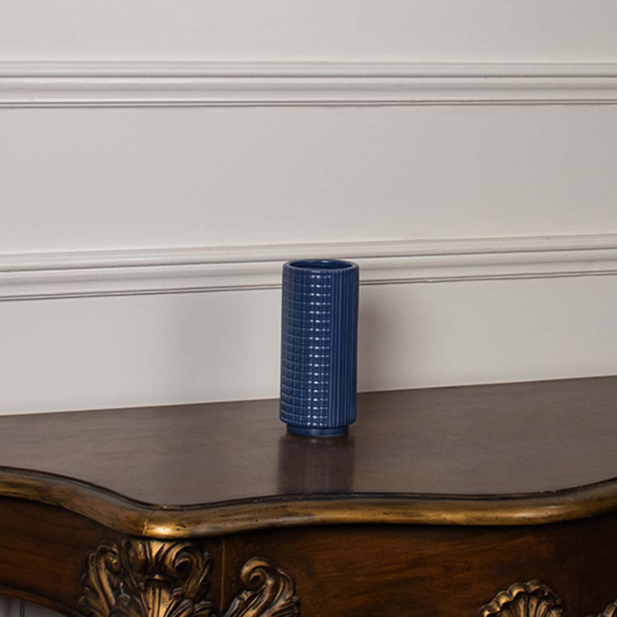 Blue textured ceramic vase displayed on a clean white background ideal for sleek home decor and elegant tabletop styling.