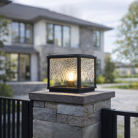 Black metal outdoor wall lantern with warm ambient glow for elegant patio lighting decor styling ideas.