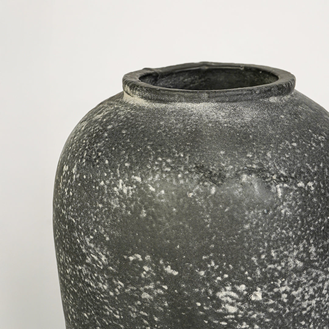 Closeup image of grey ceramic rustic vase for modern tabletop decor styling with artistic textured finish.
