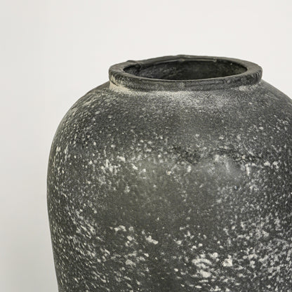 Closeup image of grey ceramic rustic vase for modern tabletop decor styling with artistic textured finish.