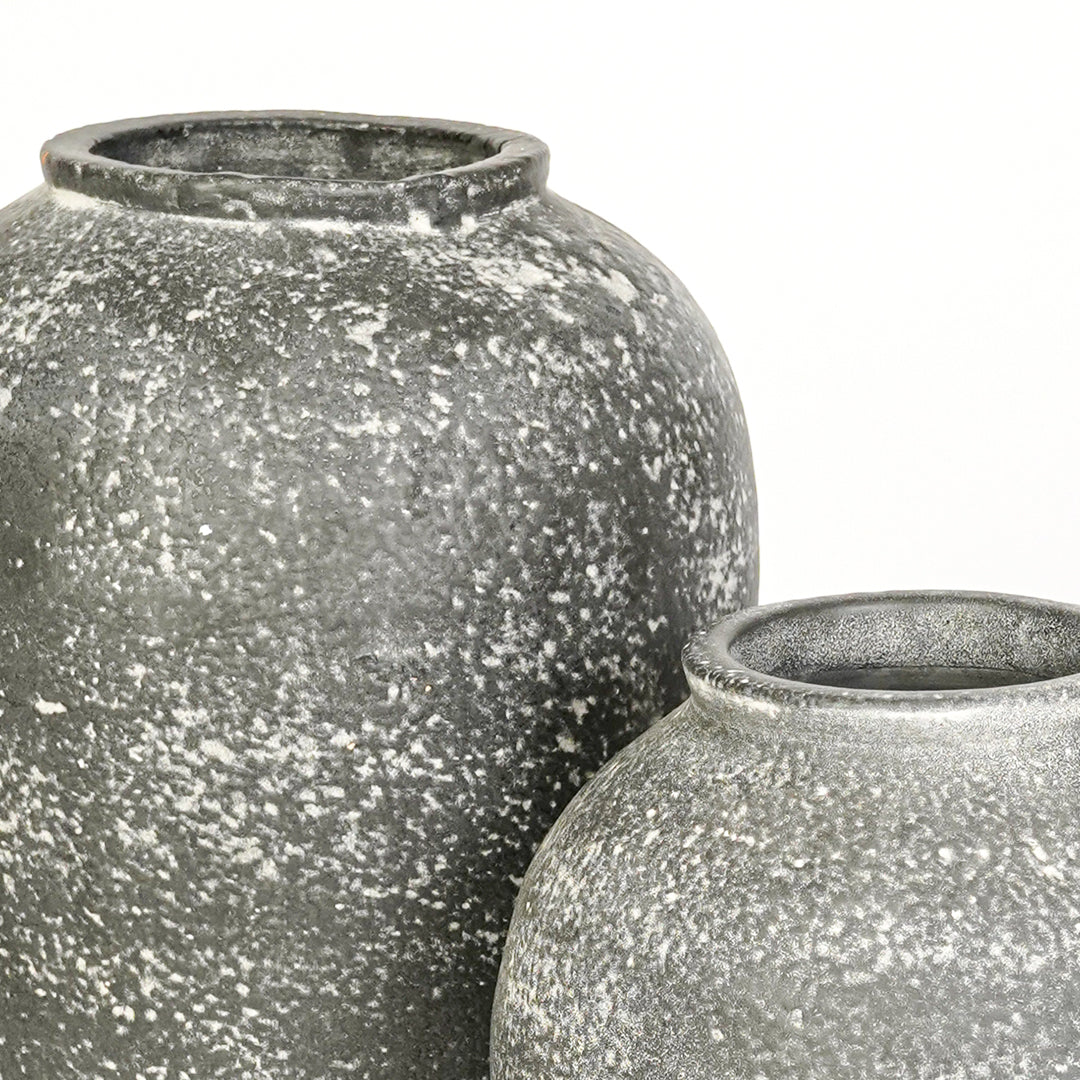 Closeup image of grey ceramic decorative vase set for modern interior styling with textured matte finish.
