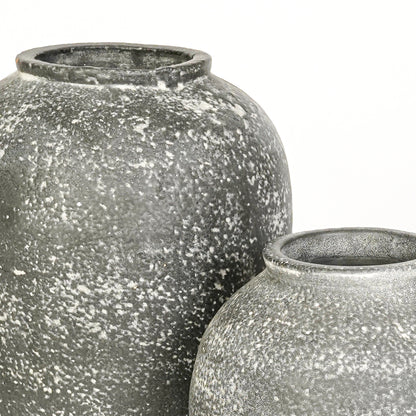 Closeup image of grey ceramic decorative vase set for modern interior styling with textured matte finish.