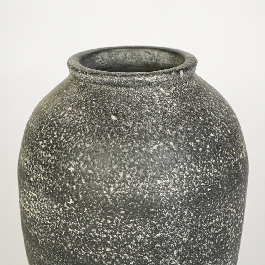 Closeup image of grey ceramic rustic vase for modern tabletop decor styling with textured matte finish.